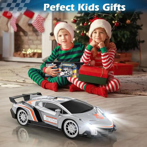 Holiday scene with kids holding gifts and a Beast One Eighteenth Scale RC Car For Kids Gift Ready with lights on.