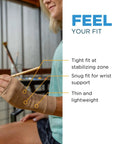 Person wearing WS6 Compression Wrist Sleeve for Carpal Tunnel Relief, showcasing snug wrist support, with FEEL YOUR FIT text.