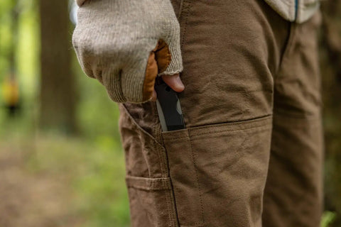 Man withdrawing Six Point One Inch Lightweight EDC Folding Knife With Stainless Steel Blade USA Made from brown pants pocket