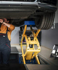 Garage scene with mechanic using 3000 Lumen LED Work Light With Adjustable Stand, Portable Flood Light for car care