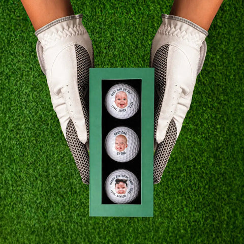 Gloved hands holding a box of personalized golf balls with faces for men dad husband grandfather and father in laws