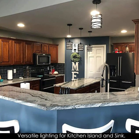 Sleek Modern Mini Pendant Light For Kitchen Island And Dining Room With 6.3 Inch Matte Black Spiral Cage And Handblown Frosted Glass Shade Adjustable Cord 1 Pack hanging over a kitchen island.