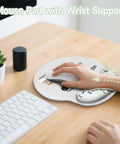 Ergonomic Mouse Pad With Gel Wrist Rest For Comfort And Pain Relief on a desk with keyboard, featuring non-slip PU base and Lycra top.