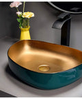 Heavy Duty Rectangular Vessel Sink Installed Above Counter From Porcelain Ceramic With A Sleek Closed Glaze and gold interior.