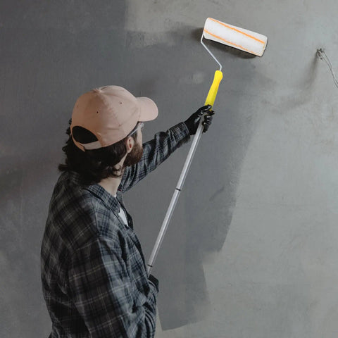 Man using Telescopic Paint Roller With Extendable Handle And Three Detachable Rods For No Sweat DIY wall painting.