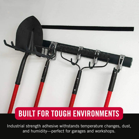 VELCRO Brand heavy-duty tape, black, 1.5-in wide, 16-ft roll mounted above wall tool rack with red-handled garden tools.