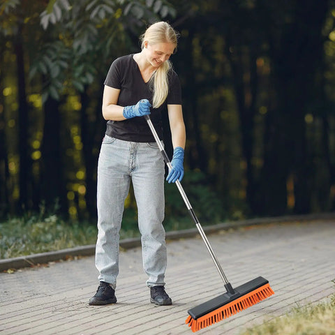 Person using 18 Inch Push Broom Outdoor With Rubber Squeegee For Heavy Duty Cleaning on a brick walkway