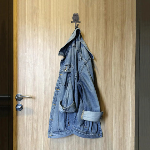 Set Of Two Cast Iron Owl Wall Hooks Super Heavy Duty Rustic Coat Rack Hangers Old School Vibe Built Like A Tank Sturdy As Nails To Hang Your Outerwear Inside with denim jacket on wooden door.