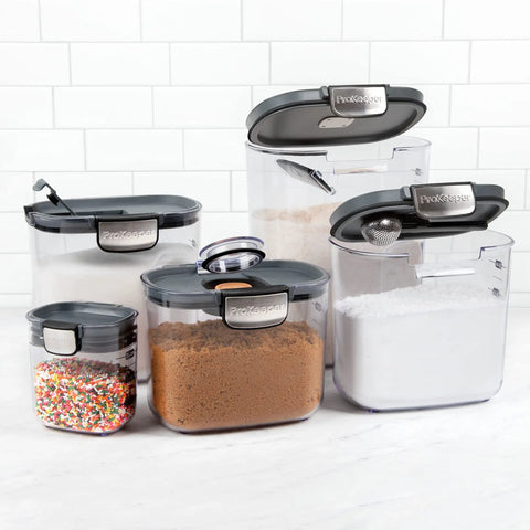 Clear Plastic Airtight Food Storage Canister Set For Flour And Sugar With Magnetic Accessories, 9-piece, grey lids, various sizes filled with ingredients.