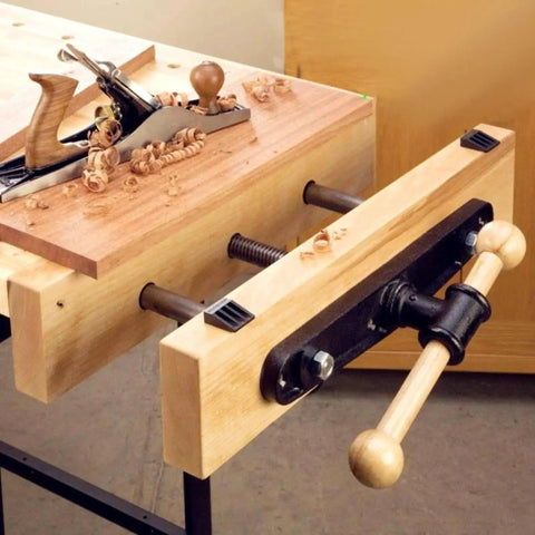 Heavy Duty Carpentry Bench Vise With Manual Threaded Screw For Tightening Workpieces During DIY Cutting Or Sanding And Assembly Projects In Your Workshop on a workbench.