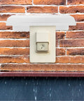 Rock Solid Outdoor EV Charger Cover Built Tough As Nails To Ward Off Rain And Grime With Smart Cross Ventilation on brick wall.