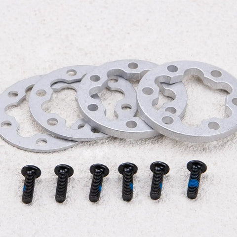 4 Pcs Aluminum E Bike Disc Brake Spacer Kit 6 Hole Universal Rotor Washers 2mm and 5mm with screws on a surface