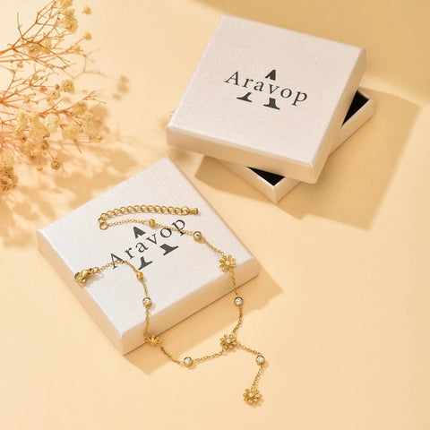 Gold Ball Stud Earrings For Women, 18K Gold Plated Stainless Steel Hypoallergenic Round Ball Studs, 2mm 3mm 4mm 5mm Size Set, Waterproof And Non Fade, Simple Yet Dope Everyday Jewelry. Gold floral chain displayed on Aravop box