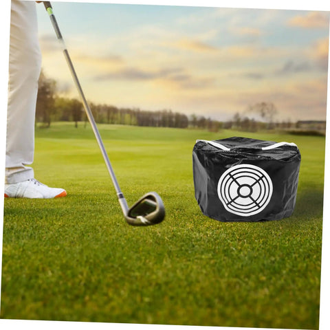 Golf Swing Trainer Bag Impact Hitting Bag For Indoor And Outdoor Practice next to golfer on green course, compact design visible