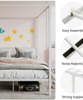 Full Size Canopy Bed Frame with Heavy Duty Metal Slats in White Four-Poster Style with pillows and bedding in a cozy room.