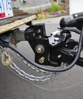 Close-up of 4Pack 3/8 Inch Clevis Slip Hooks With Latch Heavy Duty Forged Steel Safety Hooks attached to trailer hitch