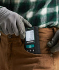 Person placing 130Ft Laser Distance Meter With Dual Bubble Levels into brown pocket.