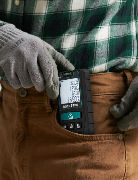Person placing 130Ft Laser Distance Meter With Dual Bubble Levels into brown pocket.