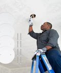 Man installing 4 pack 5 inch metal ceiling cover plates round white flat blank wall plate with screws 3.5 inch hole spacing