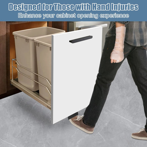 Person using foot pull for trash cabinet drawer with touchless hands free design, full overlay cabinets, modern kitchen convenience