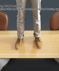 Person standing on Hella Spacious Solid Wood Desk Top For Standing Desks And Heavy Duty One Piece Workbench Surface.
