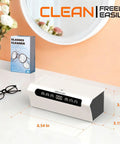 Ultrasonic Jewelry Cleaner 45KHz Machine with 4 Cleaning Modes and Sixteen Point Nine Ounce Capacity on a vanity with glasses cleaner box.