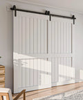 Bypass Sliding Barn Door Hardware Kit With Single Track System In Frosted Black Carbon Steel installed on white doors