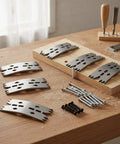 Six Piece Wood Clamping Plates Made From Stainless Steel For Carpentry And CNC Works With Serrated Design Fasteners To Grip Tight Gaps Perfect For Craftspeople And Home Workshops With Screws Included displayed on a wooden workbench.