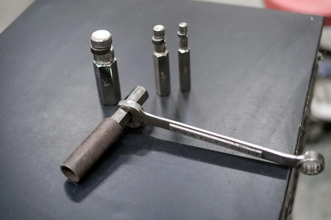 Internal Pipe Removal Tool Nipple Extractor Set Four Piece Inside Pipe Wrench Set on black surface.