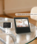 1080P Mini WiFi Pet Camera With Night Vision And Two Way Audio next to smart display showing baby room, works with Alexa