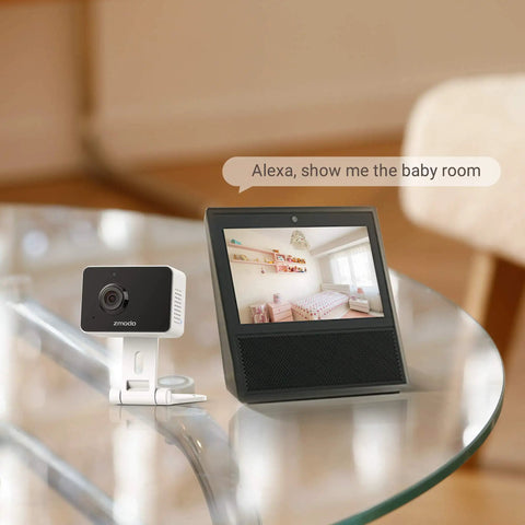 1080P Mini WiFi Pet Camera With Night Vision And Two Way Audio next to smart display showing baby room, works with Alexa