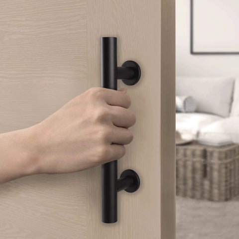 Hand holding Matte Black Barn Door Pull And Flush Mounted Handle Set For Sliding Interior Doors Includes Hardware One Pack