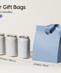 Blue paper gift bag with satin ribbon handle next to cans, showcasing small size 5.9x3.5x7.3 inches, ideal for parties and gifts.