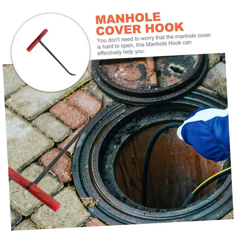 Rock Solid T Shaped Manhole Cover Lifter Hook Forged From Reinforced Steel Rod With A No Slip Grip For Reaching Down Into Deep Sewers And Yanking Open Heavy Roller Doors, shown lifting a manhole cover.