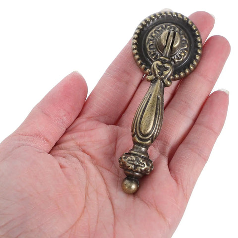 Vintage Zinc Alloy Cabinet Handle Single Hole Round Antique Pull With Bronze Finish in hand showing size and design details.