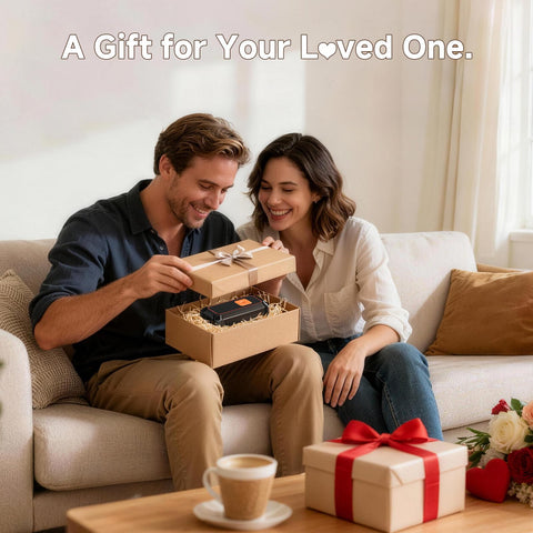 Couple opening a gift box with Cordless Tire Inflator Portable Air Compressor With Dual Power And 5400 mAh Battery on a couch