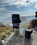 Fixed Star 1 Backpacking Stove System With Propane Cooking Gear on rock ledge during outdoor hike