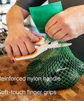 Person using Ceramic Safety Scissors With Finger Friendly Edge And Rounded Tips Heavy Duty Office Shears to cut green bag.