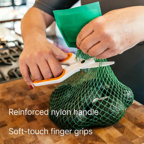 Person using Ceramic Safety Scissors With Finger Friendly Edge And Rounded Tips Heavy Duty Office Shears to cut green bag.