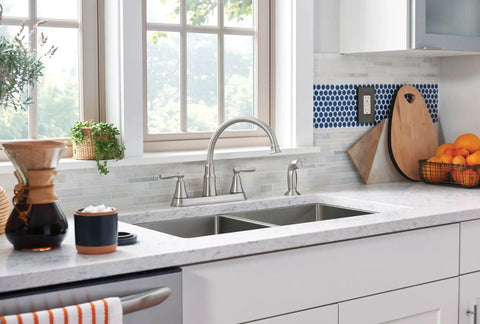 Hutchinson Spot Resist Stainless 2-Handle High Arc Kitchen Faucet With Side Sprayer installed in a modern kitchen setting