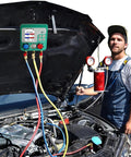 Vanlison digital HVAC manifold gauge set with red, blue and yellow hoses attached to a car engine; mechanic in overalls beside.