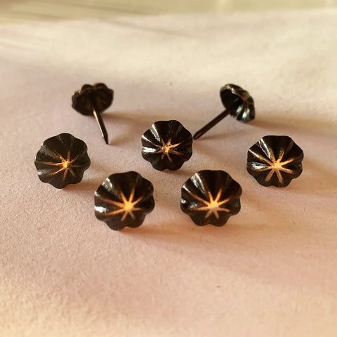 Premium 7/16 Inch Upholstery Tacks For Furniture Fix Ups, decorative black nailheads with textured design and steel points.