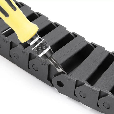 Close-up of R28 Inner 15mm By 40mm Black Plastic Wire Carrier Drag Chain for CNC, showcasing reinforced nylon links and a tool.