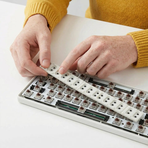 Person installing 2 Pack Conductive Rubber Contact Strips For Keyboard Buttons And Digital Pianos on a keyboard
