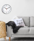 Living room with gray couch, decorative pillow, and wall-mounted quartz clock with Quartz DIY Wall Clock Movement Mechanism Battery Operated Repair Kit With 13mm Shaft And 100mm Long Hands For Easy Home Clock Fixes Custom Projects And Backyard Renovations.