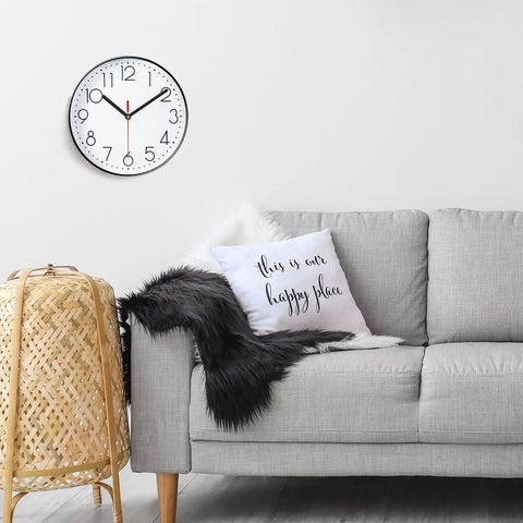 Living room with gray couch, decorative pillow, and wall-mounted quartz clock with Quartz DIY Wall Clock Movement Mechanism Battery Operated Repair Kit With 13mm Shaft And 100mm Long Hands For Easy Home Clock Fixes Custom Projects And Backyard Renovations.