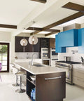 Sleek modern kitchen with island and purple chairs, showing contemporary design.