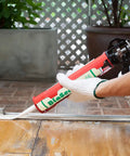 Applying Ultimate 100 Percent Silicone Sealant For Kitchen And Bath, Waterproof, Low Odor, No Yellowing, around a door frame.