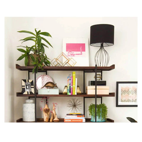 Built Different Heavy Duty Black Iron Bookshelf With Real Wood Shelves used for displaying plants, decor, and books in a stylish setup.