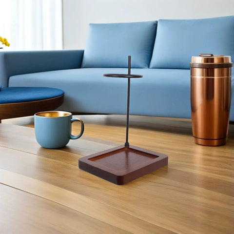 Top Shelf Wood Coffee Dripper Stand Built Tough With Stainless Base on a wooden floor next to a blue cup.